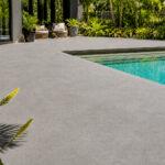 Light-tinted spraycrete pool surround on a Gold Coast residential property