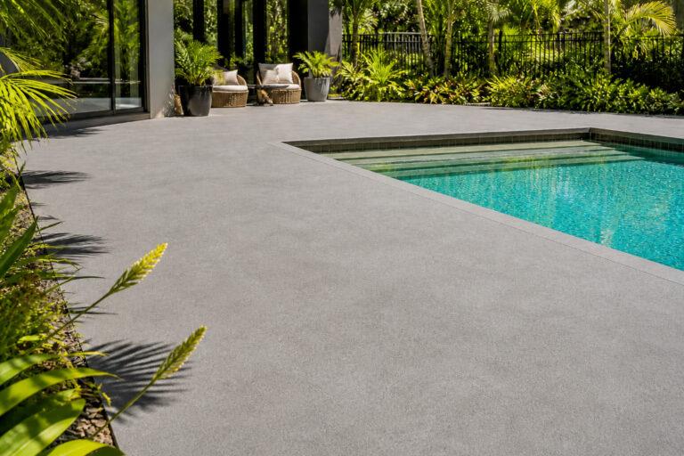 Light-tinted spraycrete pool surround on a Gold Coast residential property