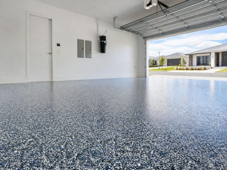 Decorative flake epoxy flooring installed in a Gold Coast residential garage, finished with a Colour Flake® blend over a coloured basecoat