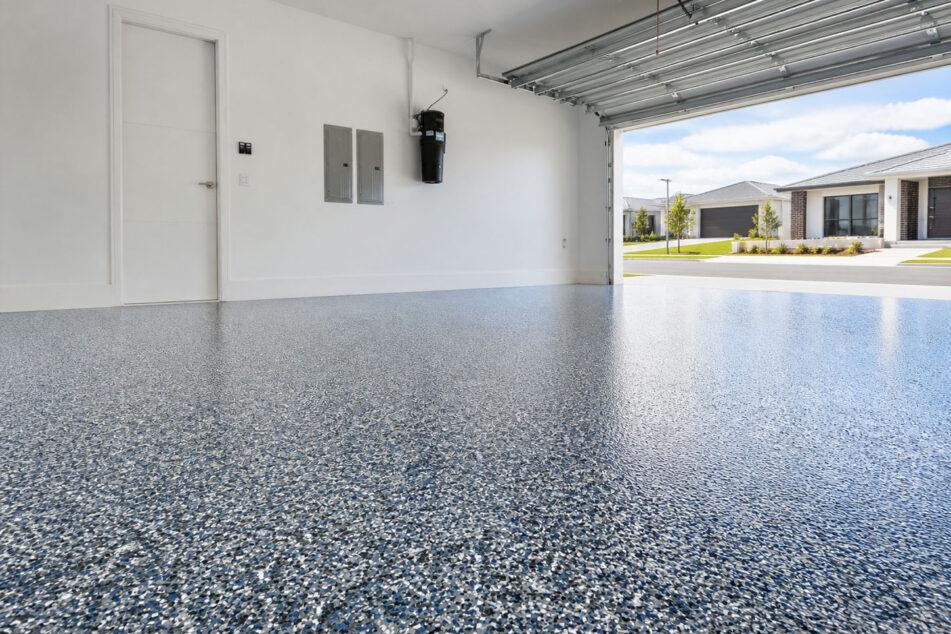 Decorative flake epoxy flooring installed in a Gold Coast residential garage, finished with a Colour Flake® blend over a coloured basecoat
