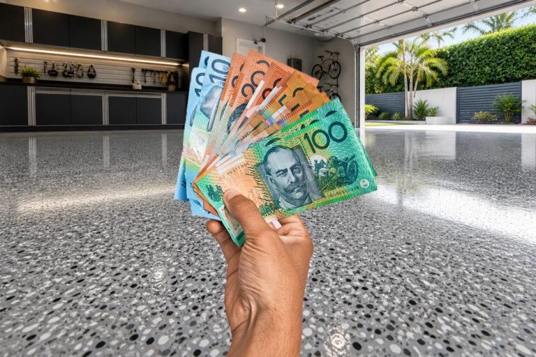 hand holding money representing epoxy flooring costs on Gold Coast