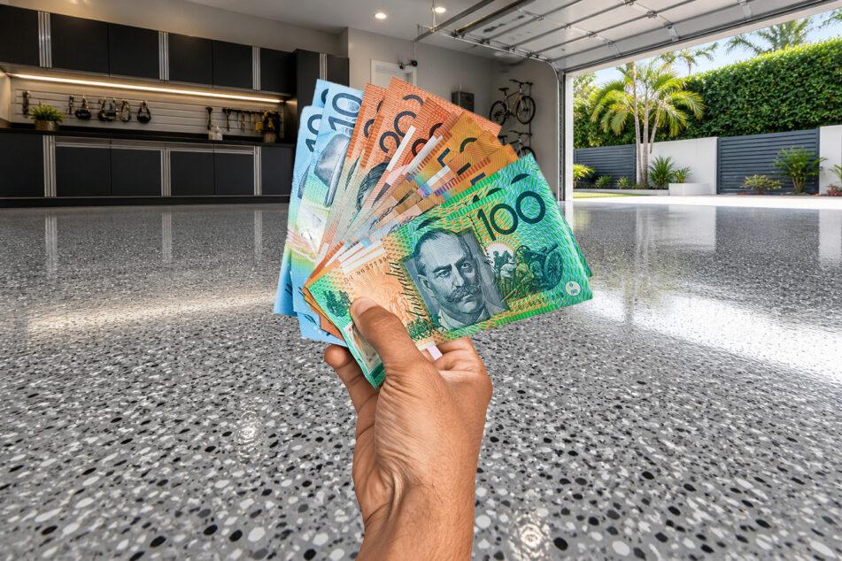 hand holding money representing epoxy flooring costs on Gold Coast