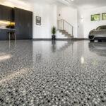 Professionally installed epoxy floor in a Gold Coast residential garage with a light grey decorative flake finish.