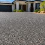 Textured concrete driveway in stone-look finish on a Gold Coast home, applied over existing concrete by Spray Your Concrete.
